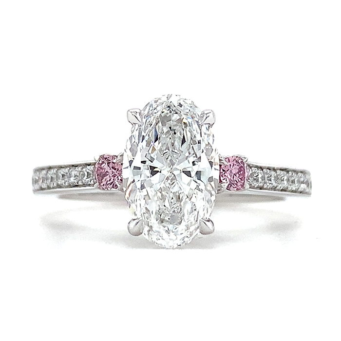 oval diamond engagement ring with pink diamond side stones