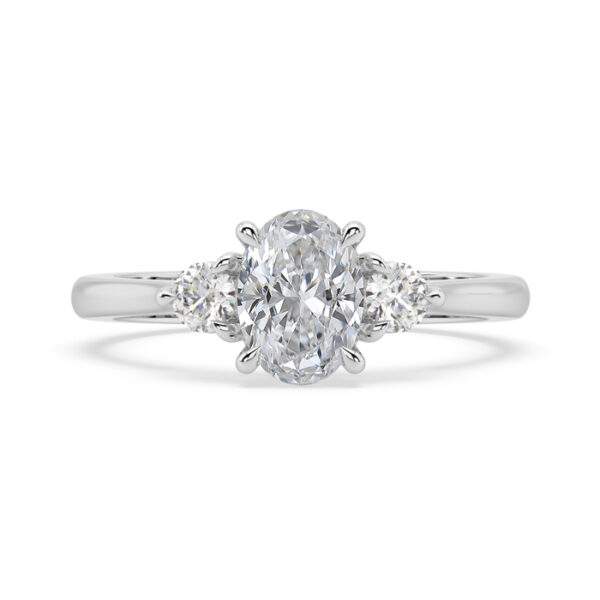 Oval diamond three stone round side ring